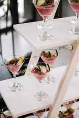 Traditional Lithuanian Cold Beetroot Soup Šaltibarščiai Served in Elegant Martini Glasses with Gourmet Garnishes for Modern Event Catering Presentation