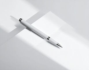 A close-up of a silver metal ballpoint pen on white paper used as a business writing tool to sign a contract or document in an office