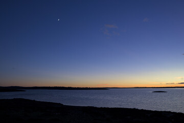 Wide Reservoir Landscape at Dusk with Crescent Moon and Clear Gradient Sky © MiguelA