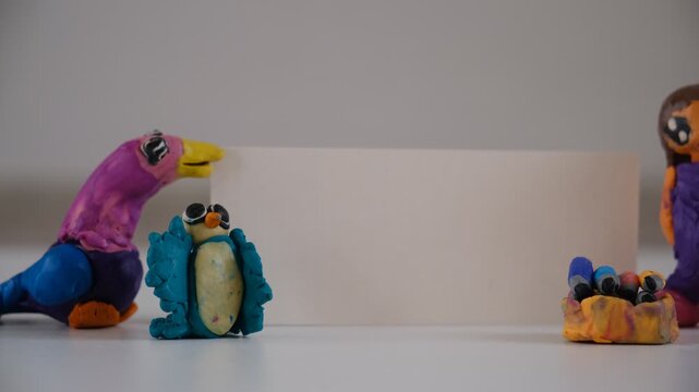 Child created plasticine figurines. Blank card, paper with space for text, information. Play is important to encourage their child's imagination and creativity. Modeling from plasticine