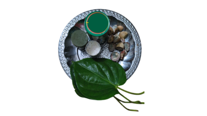 Traditional indian pooja thali with betel leaf and offerings on black