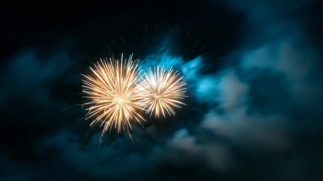 Spectacular golden fireworks illuminate night sky with vibrant bursts