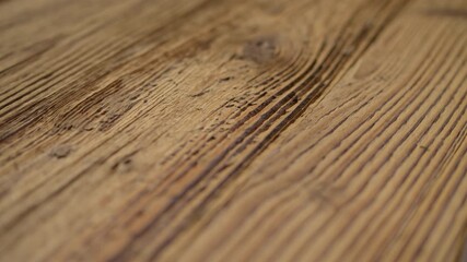 High quality video showing close up wooden surface with rich grain warm light and subtle texture captured in slow motion for a natural detailed and calm atmosphere.