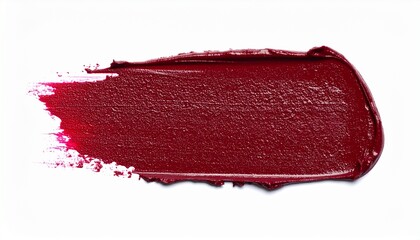 Burgundy lipstick smear on white background.