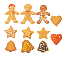 assortment of classic homemade gingerbread cookies decorated with white icing in various christmas holiday shapes, isolated on black.