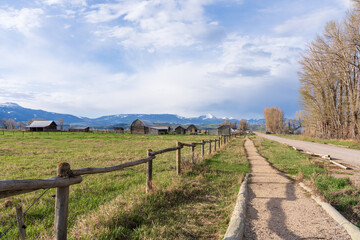 The historic T.A. Moulton Barn stands proudly with dramatic Tetons and a sky full of clouds