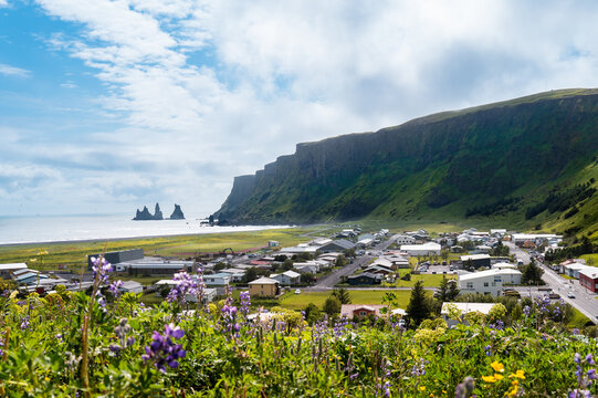 Iceland travel - City of Vik with basalt stacks Reynisdrangar and Vikurfjara black sand beach