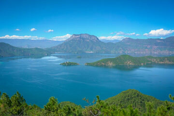 Naklejka premium Beautiful lake scenery with blue sky. Lugu Lake, Yunnan province, China.