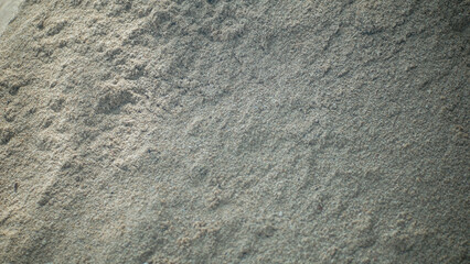 Close-up of Fine Beach Sand Texture with Subtle Footprint Impression and Natural Light