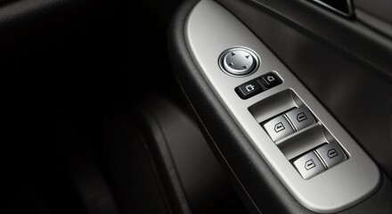 Close-up of a modern car door control panel. Vehicle interior with power window and mirror adjustment switches. Automotive technology detail with copy space