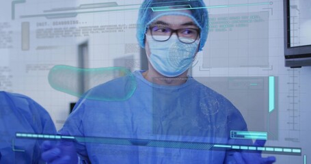 Viewing mature male clinician in blue surgical PPE studying holographic overlays in surgical suite