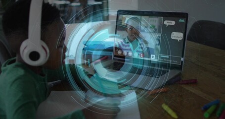 Writing girl wearing white headphones, green top at home table with laptop notebook HUD, copy space