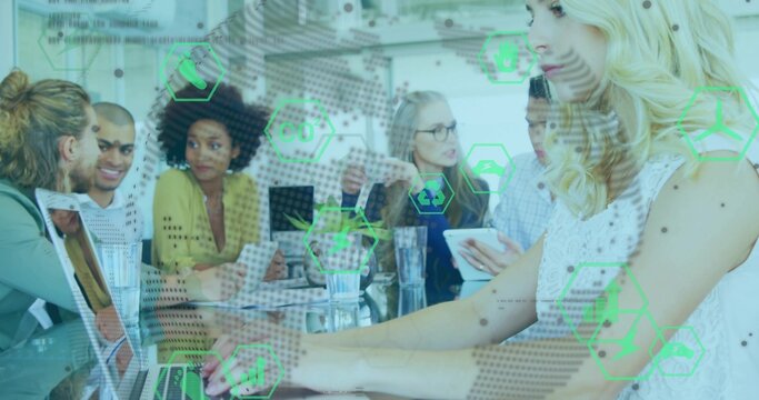 Typing blonde in sleeveless top using laptop at glass table in office, green overlays, copy space