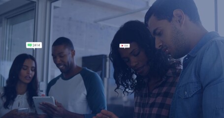 Leaning team in casual business attire, viewing tablet and phones in office, showing badges