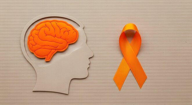Orange ribbon symbolizing awareness and support for brain health and neurological disorders alongside a silhouette of a human head with a brain illustration