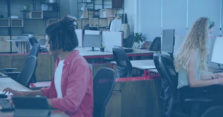Working adult woman in red shirt using tablet and keyboard at open office, copy space
