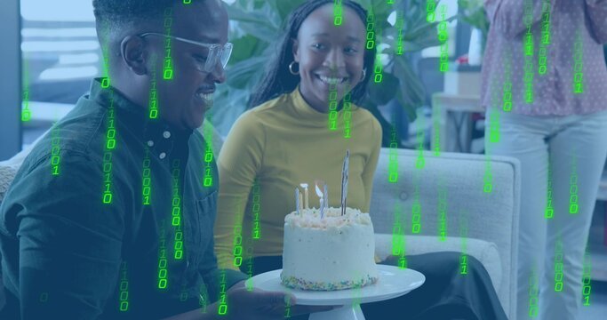Holding man wearing glasses and woman in mustard top showing cake on pedestal sofa, binary overlay - Powered by Adobe