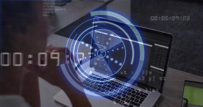 Displaying open laptop code HUD timer on desk, woman in light top by green tablet