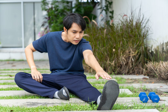 Man lifestyle stretching exercise outdoor fitness training with dumbbell weights - Powered by Adobe