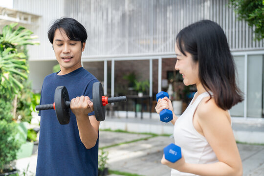 Man lifestyle fitness exercise outdoor training couple weightlifting dumbbell healthy activity - Powered by Adobe