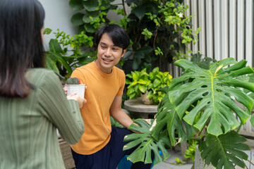 Man lifestyle gardening plant green leaves smiling happy outdoor