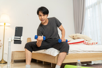 Man lifestyle exercising dumbbell fitness indoor home workout motivation