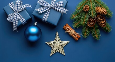 Christmas composition with blue gifts, ornaments, pine branch, and spice