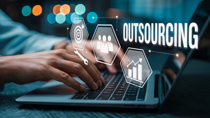 Streamline your business operations with outsourcing solutions for efficiency and growth, a skilled professional working on their laptop to success