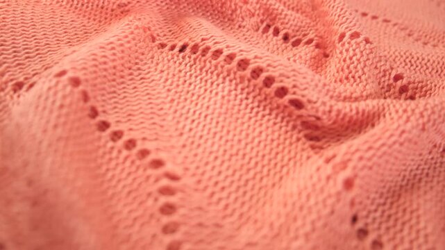 Product from wool. Reverse side. Handwork , Folded in waves and folds textiles, close up fabric. Detailed warm yarn background. Cardigan, sweater