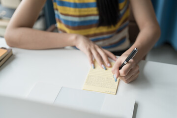 Online Tutoring Asian Girl in Headphones Engaged in Online Class with Laptop education writing homework study e-learning preparing for exam