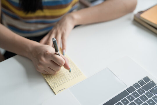 Online Tutoring Asian Girl in Headphones Engaged in Online Class with Laptop education writing homework study e-learning preparing for exam - Powered by Adobe