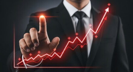 Businessman in a suit touching a glowing red upwardtrending financial graph, symbolizing business growth success