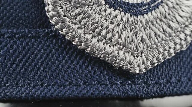 Macro shot of navy blue law enforcement uniform fabric and embroidered patch