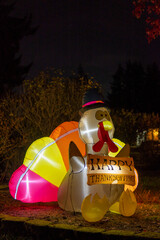 Glowing outdoor inflatable turkey figure in the hat with inscription - Happy Thanksgiving