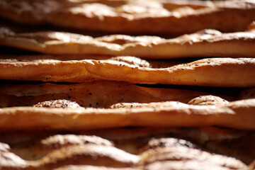 Freshly baked bread cooling on wooden racks in a bakery