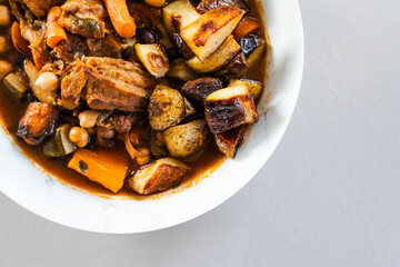 veggie stew bowl with roasted potatoes carrots zucchini and plant based chicken strips