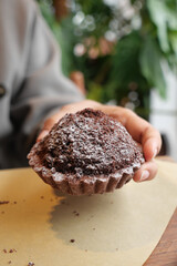 Delicious chocolate dessert held in a cozy cafe setting