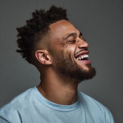 Obraz premium Modern portrait of a happy young man radiating positive vibes in simplicity. Editorial style. Effervescent joy immortalized: young man in blue t-shirt with artful backdrop. High resolution.