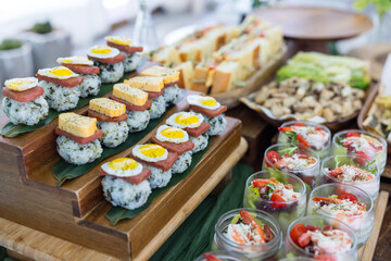 Buffet with cooked sushi and fresh salad selection