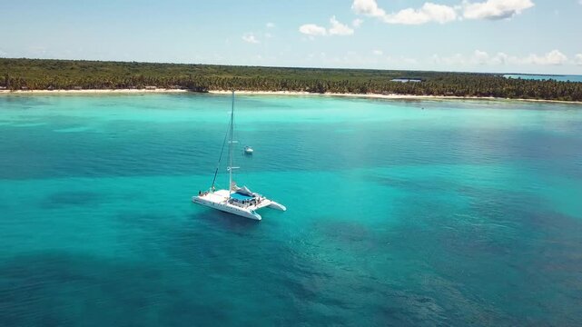4k 24fps drone shoot of the catamaran in the saona island in the caribbean sea with blue water in a sunny day 6
