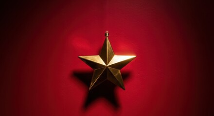 Golden hanging star ornament shining brightly on a rich festive red backdrop