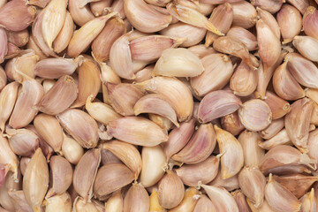 Top view of pile of thai garlic cloves for background.