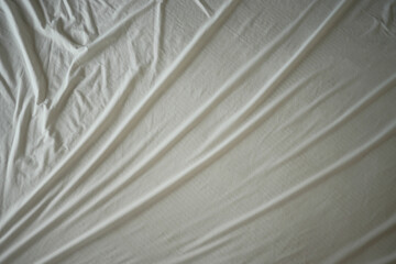 Soft white fabric draped gently on a flat surface