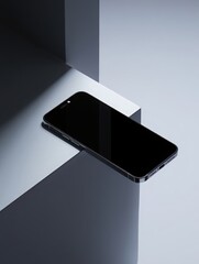 Sleek black smartphone resting on a modern geometric surface