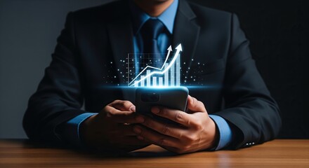 Businessman using smartphone displaying glowing upward trending financial growth chart hologram