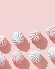 Minimal style photo homemade marshmallow meringues, pastel pink and white. Zefir dessert on pink background. Top view zephyr, pastel colors sweet dessert, romance holiday mood, creative still life