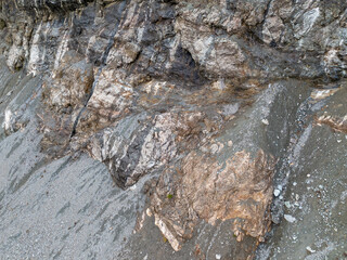 Rugged Rock Cliff Texture With Layered Strata and Weathered Stone Surface