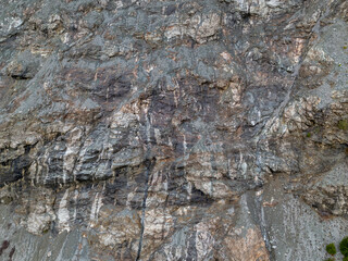 Rugged Rock Face in Cliffside Terrain with Striated Gray Stones, BC Canada