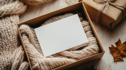 Opened gift box with white blank card and scarf. Merry Christmas and Happy New Year concept.