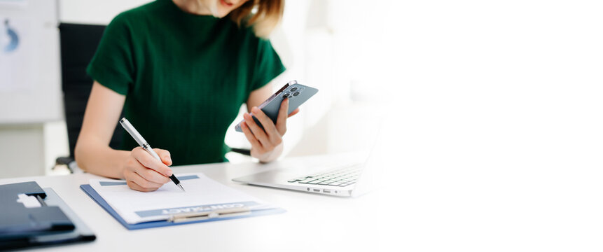 Businesswoman hand working digital marketing media in virtual screen with mobile phone and modern compute with VR icon diagram at office